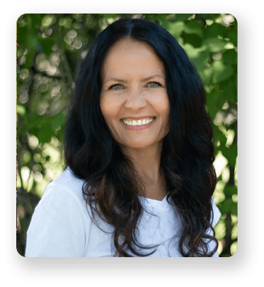 A woman with long hair smiling for the camera.