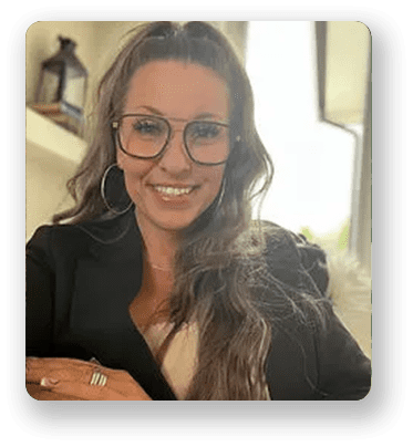 A woman with glasses smiling for the camera.