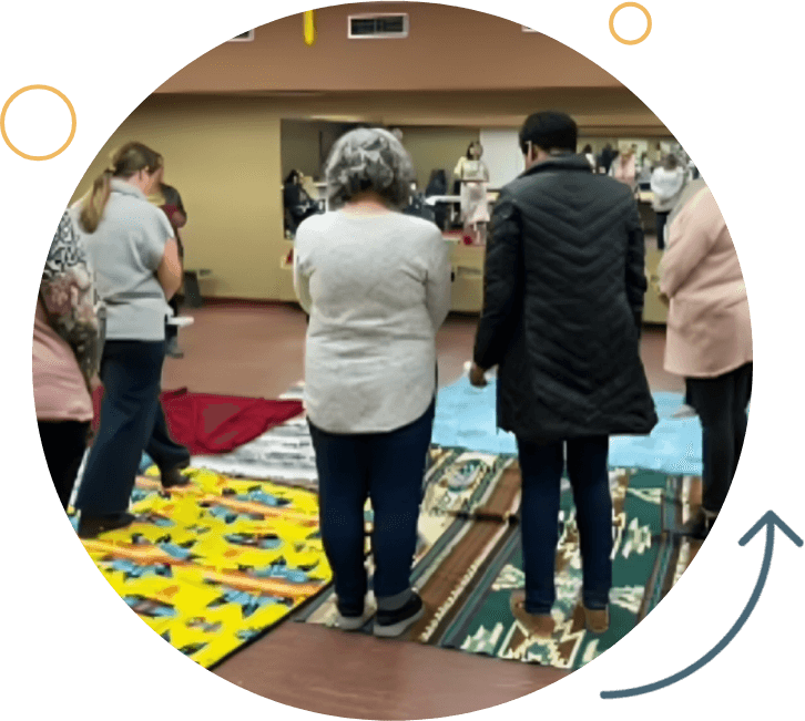 A group of people standing around in a room.